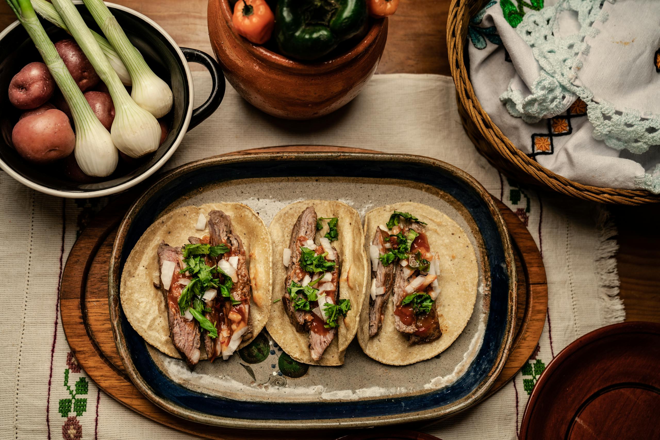 Sliced Beef Steak and Green Vegetable on Top of Tortilla Placed on a Ceramic Plate